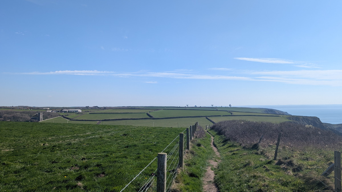 The approach to Morwenstow with the village inland and GCHQ Bude in the distance