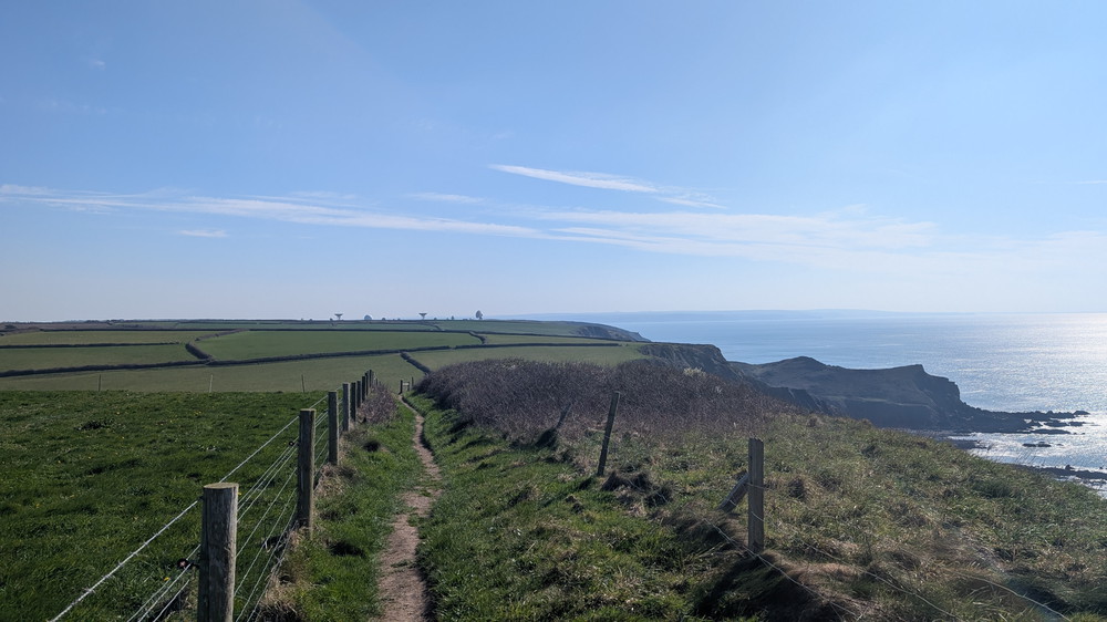 The approach to Morwenstow with the village inland and GCHQ Bude in the distance