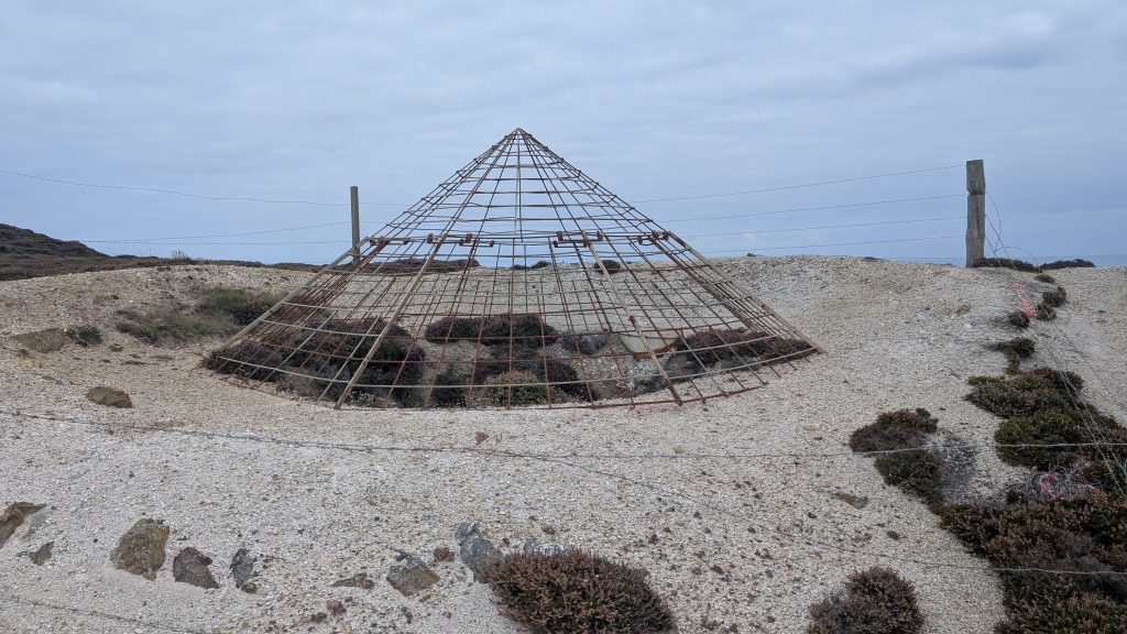 A conical wire frame over a mine shaft allowing access to bats.- one of many along the route