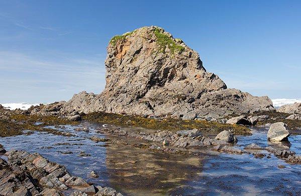 A stack composed of slump breccia - large balls of sandstone and contorted thinner sandstone units,
set in a dark grey succession of siltstone and mudstone.